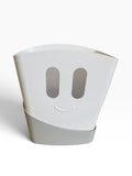 White bath toy storage bucket with smiley-face design and gray base