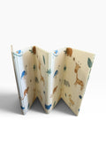 Animal print play mat partially unfolded showing accordion-style folds